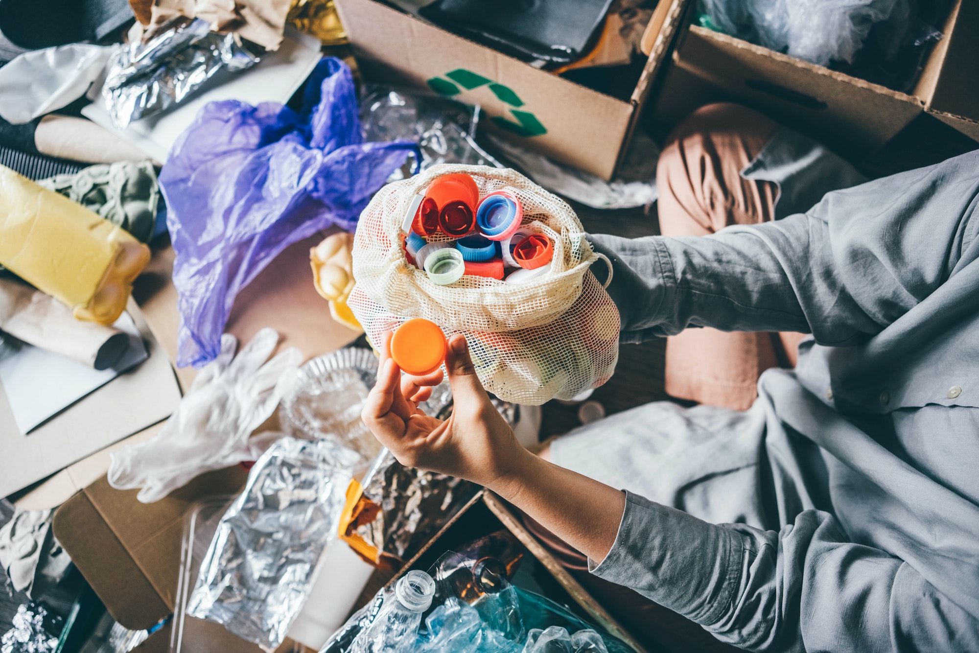 woman-sorting-different-waste-girl-holding-a-plastic-cap-recycling-and-ecology-concept-.jpg